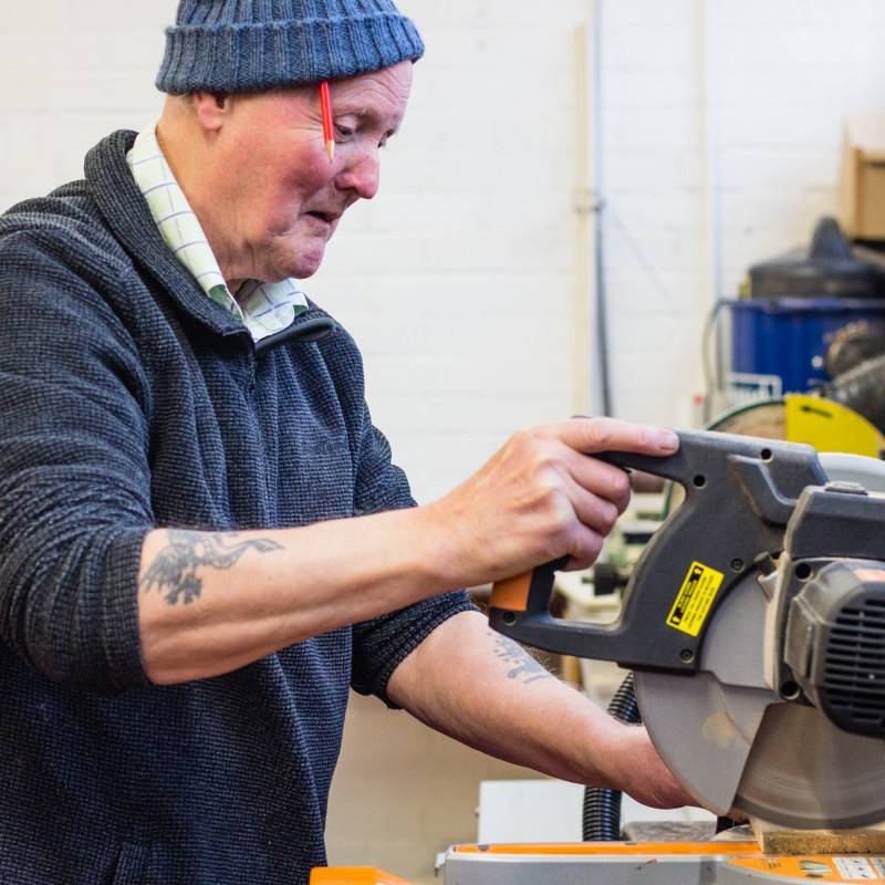 Men in Sheds Member using a saw