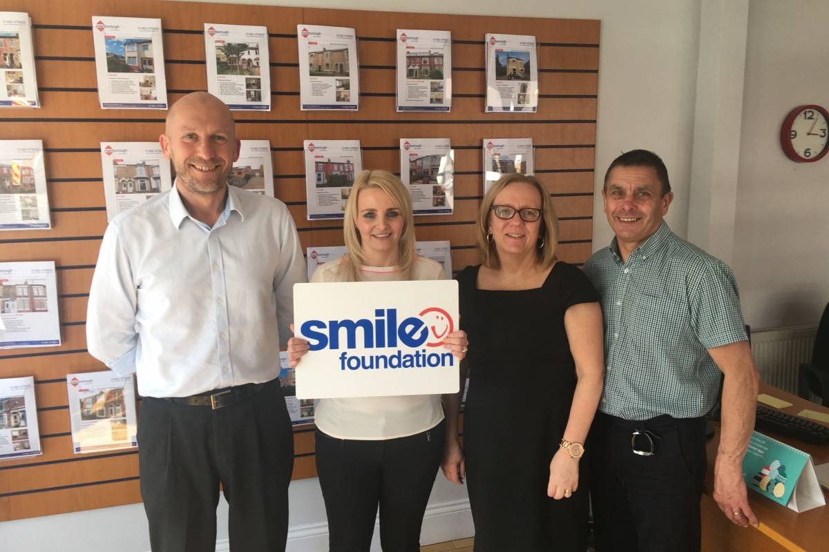 Marlborough Property Team holding Smile Foundation sign